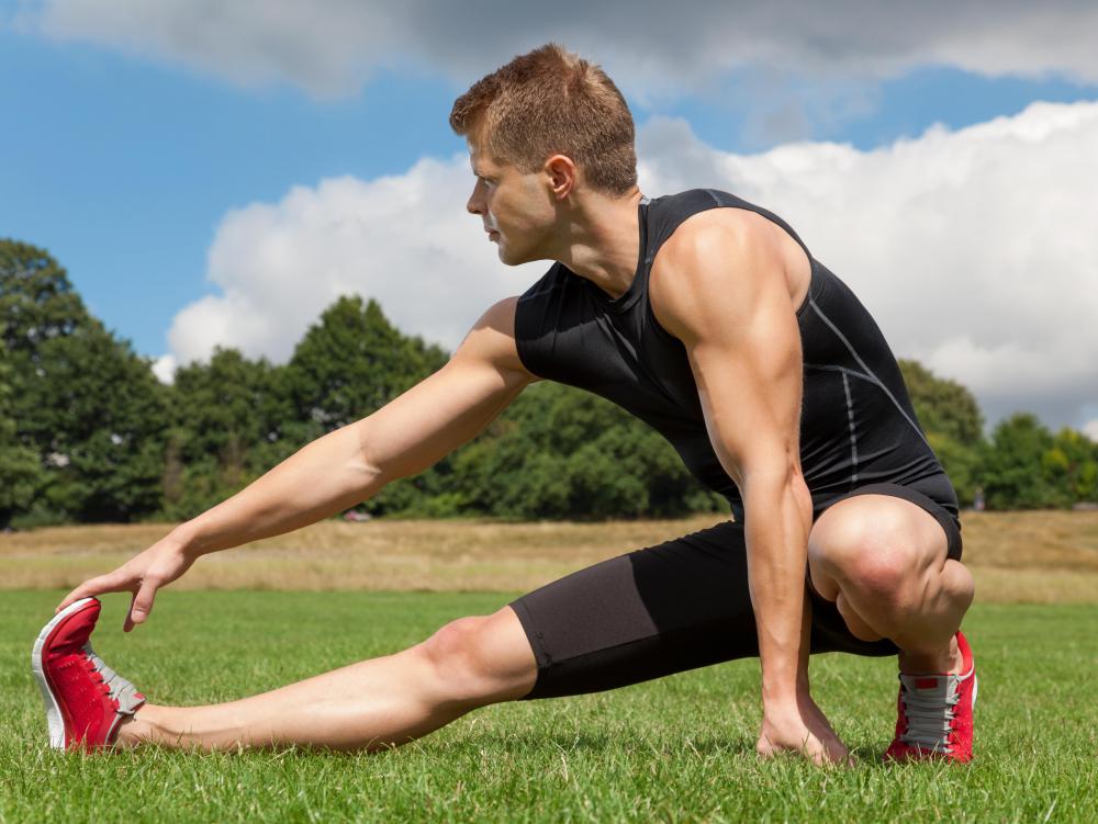 man-in-black-stretching-on-grass.jpg